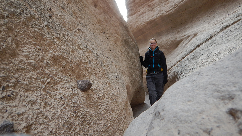 a woman posing in a narrow canyon